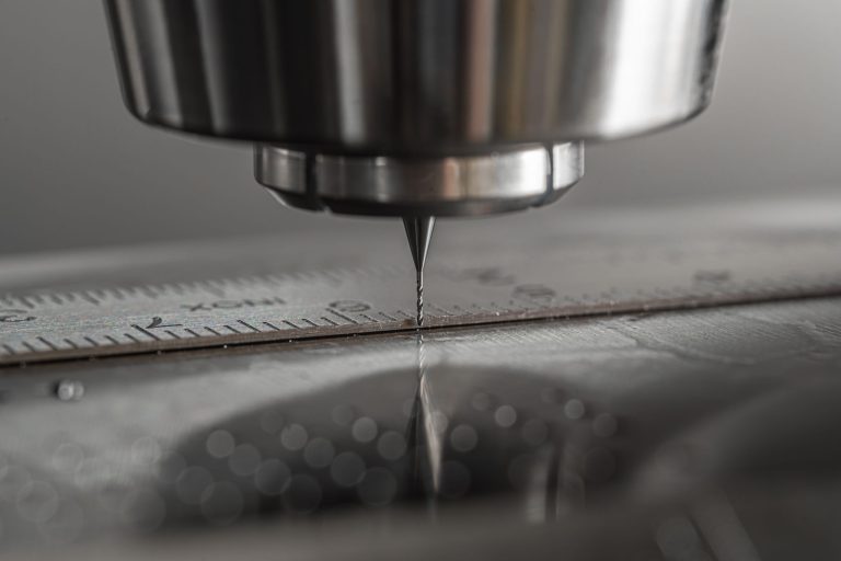 Detailed close-up of a CNC milling machine working on metal, showcasing precision and industry technology.
